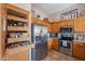 Spacious kitchen features a stainless steel refrigerator and a unique, pull-out pantry at 6397 S Pinaleno Pl, Chandler, AZ 85249