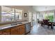 This kitchen features wood cabinets, a stainless steel dishwasher, and a large window with a backyard view at 6397 S Pinaleno Pl, Chandler, AZ 85249