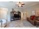 Inviting living room and couch area with a TV cabinet, ceiling fan, and warm neutral paint at 6397 S Pinaleno Pl, Chandler, AZ 85249