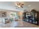 Comfortable living room area with large TV and built-in cabinet and natural lighting at 6397 S Pinaleno Pl, Chandler, AZ 85249