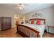 Cozy main bedroom with a wooden bed frame, decorative pillows, and a ceiling fan at 6397 S Pinaleno Pl, Chandler, AZ 85249