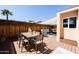 Charming back patio with a dining table, cozy seating area, and stylish shade, ideal for outdoor gatherings at 6526 N 13Th Dr, Phoenix, AZ 85013