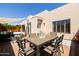 Inviting back patio featuring an outdoor dining set and comfortable lounge area, perfect for relaxation and entertaining at 6526 N 13Th Dr, Phoenix, AZ 85013