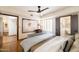 This bedroom offers hardwood floors, a ceiling fan, and two doorways for convenience at 6526 N 13Th Dr, Phoenix, AZ 85013