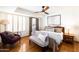 This bedroom boasts hardwood floors, a ceiling fan, and an ensuite bathroom at 6526 N 13Th Dr, Phoenix, AZ 85013