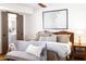 Well lit bedroom has hardwood floors, a ceiling fan, and an ensuite bathroom at 6526 N 13Th Dr, Phoenix, AZ 85013