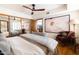 Bright bedroom features a mirrored closet, ceiling fan, and direct access to an ensuite at 6526 N 13Th Dr, Phoenix, AZ 85013