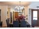Dining area featuring hardwood floors, designer lighting, and views into the kitchen at 6526 N 13Th Dr, Phoenix, AZ 85013