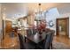 Bright dining area features a black chandelier and a table with gray upholstered chairs at 6526 N 13Th Dr, Phoenix, AZ 85013