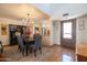 Dining room featuring hardwood floors, designer lighting, and a view of the kitchen at 6526 N 13Th Dr, Phoenix, AZ 85013