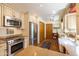 Well-lit kitchen with stainless steel appliances, custom cabinets, and granite countertops at 6526 N 13Th Dr, Phoenix, AZ 85013