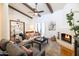 Inviting living room featuring beamed ceilings, a cozy fireplace, and stylish furnishings at 6526 N 13Th Dr, Phoenix, AZ 85013