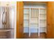 Pantry next to stainless steel fridge with open shelving provides ample storage at 6526 N 13Th Dr, Phoenix, AZ 85013