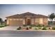 Charming single-story home featuring a tile roof, a two-car garage, and desert landscaping at 6996 W Hedge Hog Pl, Peoria, AZ 85383
