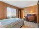 Comfortable bedroom with wood paneling, providing a relaxing retreat at 701 S Dobson Rd # 259, Mesa, AZ 85202