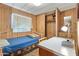 This bedroom features a single bed, a desk, and wood paneled walls at 701 S Dobson Rd # 259, Mesa, AZ 85202