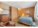This bedroom features a single bed, a desk, and wood paneled walls at 701 S Dobson Rd # 259, Mesa, AZ 85202