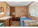 This bedroom features a single bed, a desk, and wood paneled walls at 701 S Dobson Rd # 259, Mesa, AZ 85202