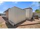 Exterior showing storage shed with siding, decorative landscaping, and manufactured home at 701 S Dobson Rd # 259, Mesa, AZ 85202