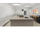 Bright laundry room featuring multiple washers and dryers with a sink and folding table at 701 S Dobson Rd # 259, Mesa, AZ 85202