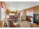 Cozy living room featuring comfortable seating, wood paneling, and a view to the kitchen at 701 S Dobson Rd # 259, Mesa, AZ 85202