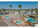 Inviting community pools and spa surrounded by palm trees and ample lounging space at 701 S Dobson Rd # 259, Mesa, AZ 85202