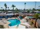 Aerial view of community pools with lounge chairs and umbrellas amidst lush landscaping at 701 S Dobson Rd # 259, Mesa, AZ 85202