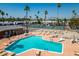 Community pool with plenty of chairs available for residents to relax and enjoy the sun at 701 S Dobson Rd # 259, Mesa, AZ 85202