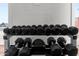 Weight rack with dumbbells of various sizes in a well-equipped fitness center at 701 S Dobson Rd # 259, Mesa, AZ 85202