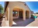 Covered backyard patio with brick pavers and arched supports, perfect for outdoor entertaining at 7159 S Dodane Ct, Gilbert, AZ 85298