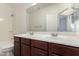 Bright bathroom features a double sink vanity with spacious countertop and a large mirror at 7159 S Dodane Ct, Gilbert, AZ 85298