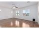 Bright bedroom with natural light, wood-look floors, and white walls at 7159 S Dodane Ct, Gilbert, AZ 85298