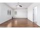 Neutral bedroom with wood-look flooring and ample natural light at 7159 S Dodane Ct, Gilbert, AZ 85298