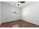Bedroom exhibiting wood flooring, a ceiling fan, and a window with shutter blinds at 7159 S Dodane Ct, Gilbert, AZ 85298