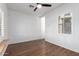 Bedroom offering wood flooring, ceiling fan, and bright windows with shutter-style blinds at 7159 S Dodane Ct, Gilbert, AZ 85298