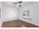 Bedroom displays wood floors, a ceiling fan, and a window offering natural light at 7159 S Dodane Ct, Gilbert, AZ 85298