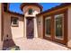 Private front courtyard with brick pavers, a decorative iron gate, and a covered entry at 7159 S Dodane Ct, Gilbert, AZ 85298