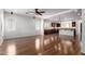 Open-concept living room and kitchen with wood-look flooring and neutral paint at 7159 S Dodane Ct, Gilbert, AZ 85298