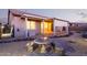 Charming backyard patio with table, landscaped gravel, and covered patio with retractable shade feature at 7234 S 28Th Ln, Phoenix, AZ 85041