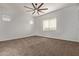 Bright bedroom with neutral carpet, a ceiling fan and natural light streaming through the windows at 7234 S 28Th Ln, Phoenix, AZ 85041