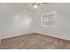 Empty bedroom featuring neutral walls, carpet, a ceiling fan, and natural light at 7234 S 28Th Ln, Phoenix, AZ 85041