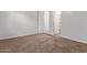 Neutral-toned bedroom with carpet and two doors leading to the hallway and closet at 7234 S 28Th Ln, Phoenix, AZ 85041