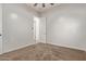 Comfortable carpeted bedroom with a view of a hallway and a neutral color scheme at 7234 S 28Th Ln, Phoenix, AZ 85041