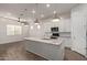 Open kitchen concept with a large island, stainless steel appliances, and a seamless transition to the living area at 7234 S 28Th Ln, Phoenix, AZ 85041