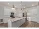 Modern kitchen with stainless steel appliances, ample counter space, and sleek white cabinetry at 7234 S 28Th Ln, Phoenix, AZ 85041