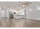 Bright living space with wood-look floors open to kitchen with island at 7234 S 28Th Ln, Phoenix, AZ 85041