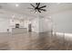 Bright and airy living room with wood-style flooring seamlessly transitions into the modern kitchen at 7234 S 28Th Ln, Phoenix, AZ 85041