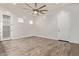 Open-concept living space with wood-look floors, modern lighting, and neutral walls at 7234 S 28Th Ln, Phoenix, AZ 85041