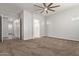 Spacious main bedroom with ceiling fan, carpet and ensuite bathroom at 7234 S 28Th Ln, Phoenix, AZ 85041