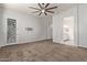 Large carpeted main bedroom with ceiling fan and a door leading to the backyard at 7234 S 28Th Ln, Phoenix, AZ 85041